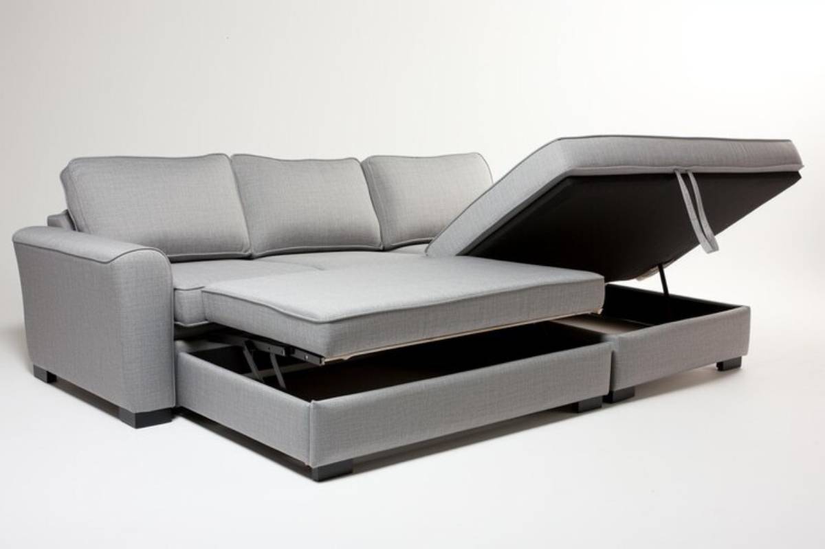 A stylish gray sectional sofa with a reclining chaise and storage drawer beneath, featuring smooth fabric and a modern design.