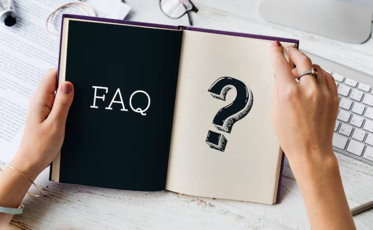 A person holding an open book displaying FAQ on one page and a large question mark on the other, symbolizing inquiry. 